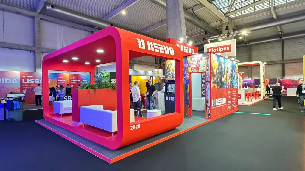 Side structure of Reevo's stand at ICE 2025, highlighting its red design, creative graphics, and branding.